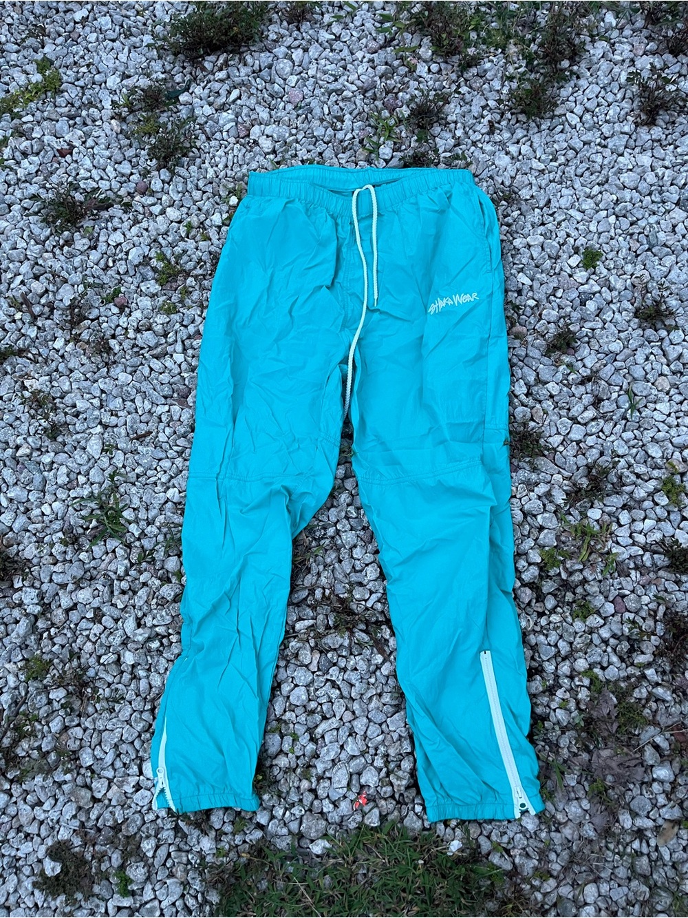 Mes Shaka wear Turquoise Track Pants with Zipper Ankles